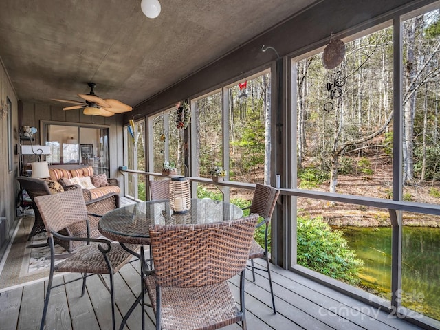 unfurnished sunroom with ceiling fan and a wealth of natural light