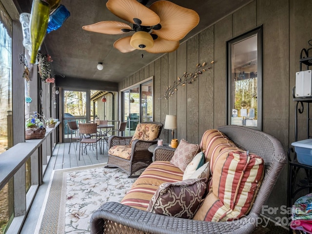 sunroom / solarium featuring ceiling fan