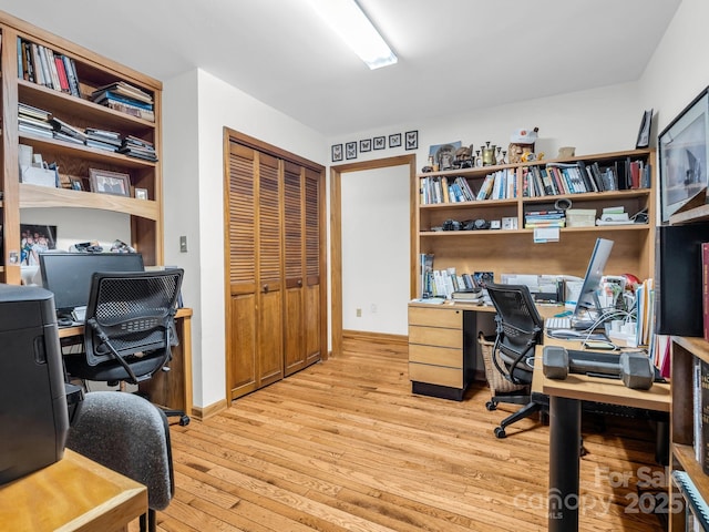 office space with light wood-style flooring and baseboards