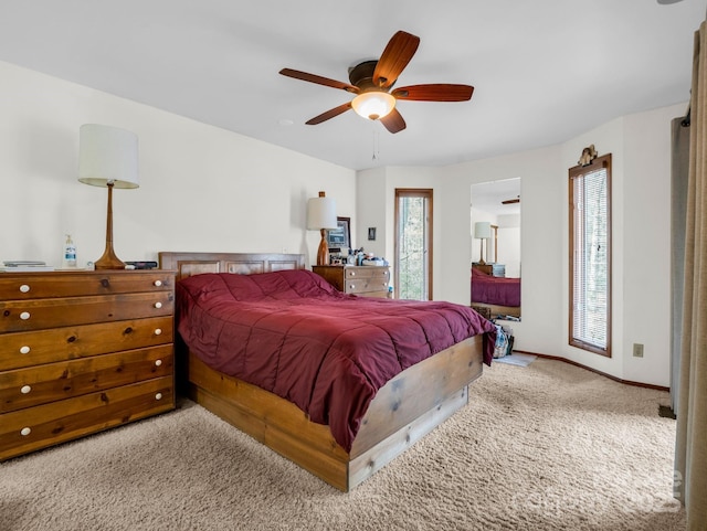 bedroom featuring light carpet, ceiling fan, and baseboards