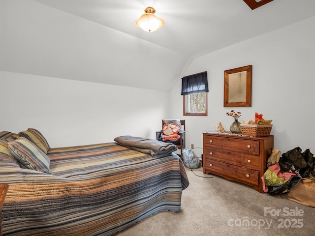 bedroom with lofted ceiling and light colored carpet