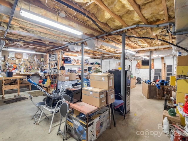 unfinished basement featuring a workshop area