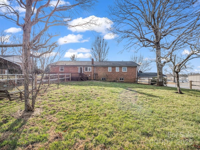 back of property featuring a lawn