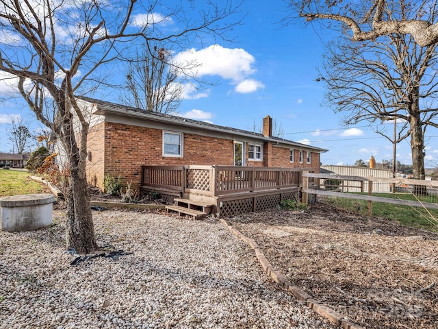 rear view of property with a wooden deck