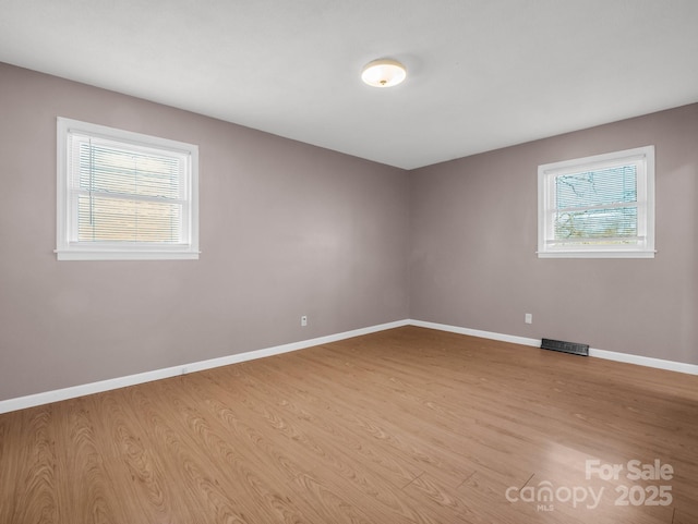 unfurnished room with light wood-type flooring