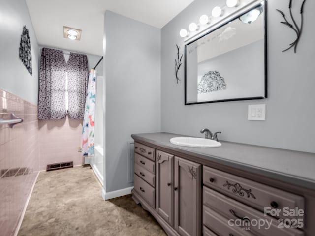 bathroom featuring vanity and shower / bath combo with shower curtain