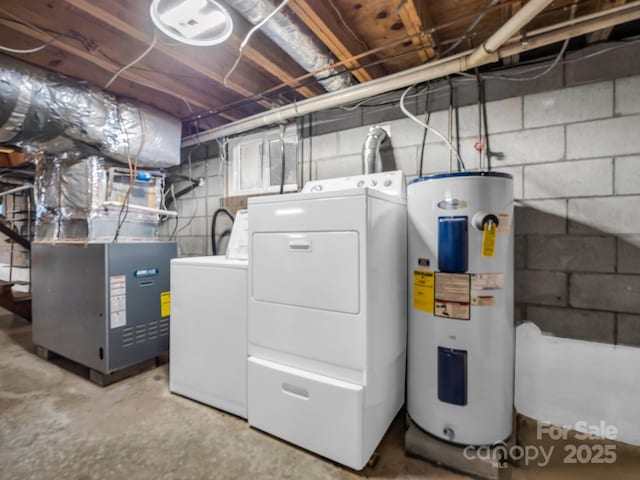 utility room featuring water heater, heating unit, and washer and clothes dryer