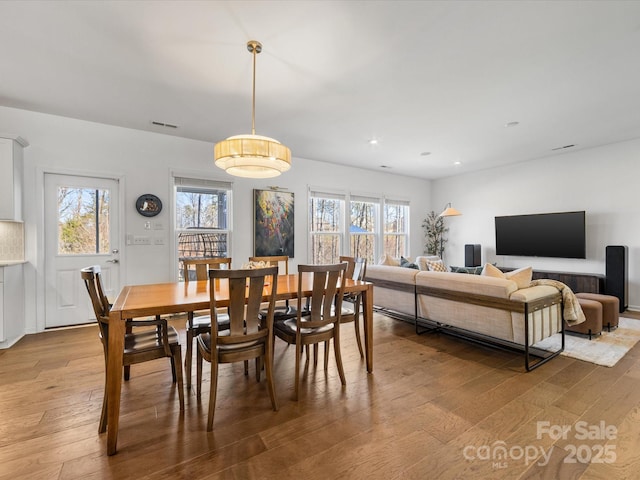 dining area with recessed lighting, wood finished floors, and a healthy amount of sunlight