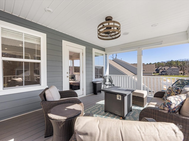 deck featuring an outdoor living space with a fire pit and a residential view