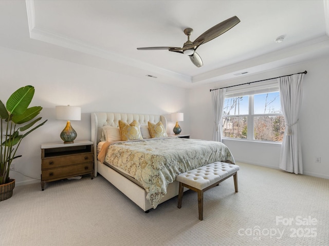 bedroom featuring a tray ceiling, visible vents, light carpet, and baseboards