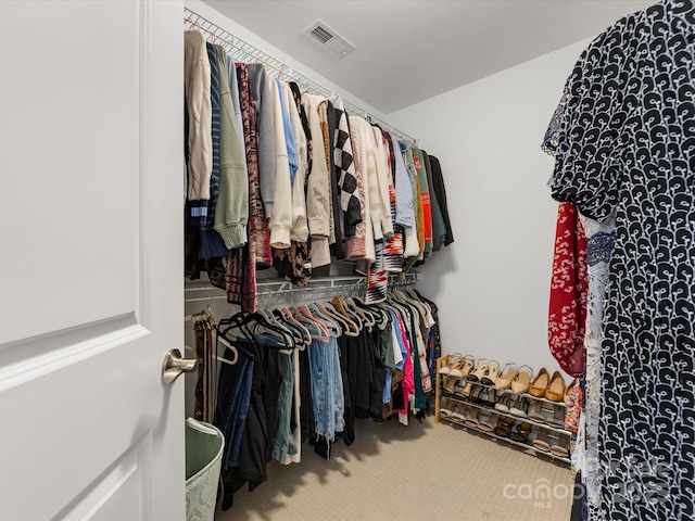 walk in closet with visible vents and carpet flooring