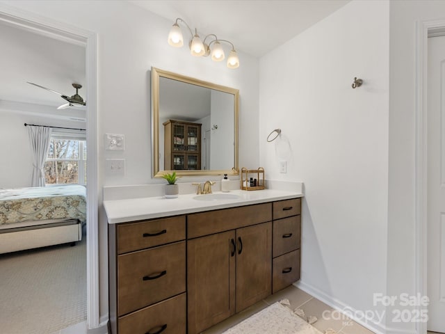 ensuite bathroom featuring tile patterned flooring, ensuite bath, vanity, and a ceiling fan