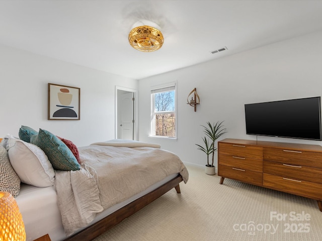 bedroom with visible vents and light colored carpet