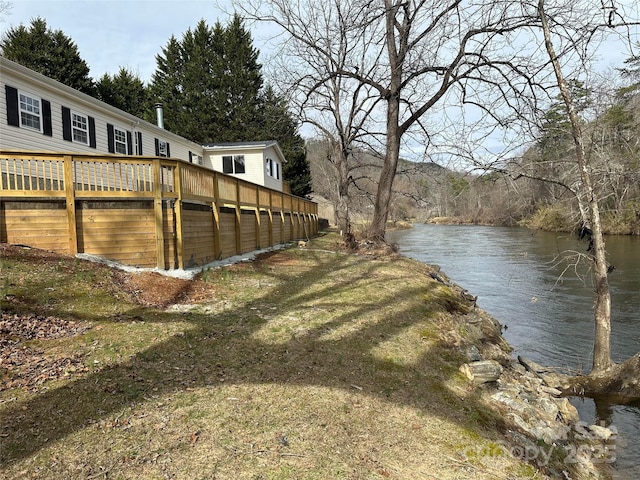 view of yard featuring a deck with water view