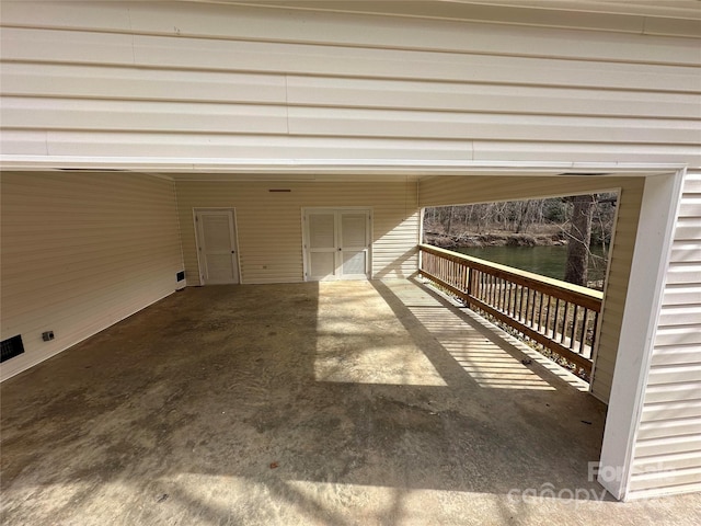 exterior space with a carport and a water view