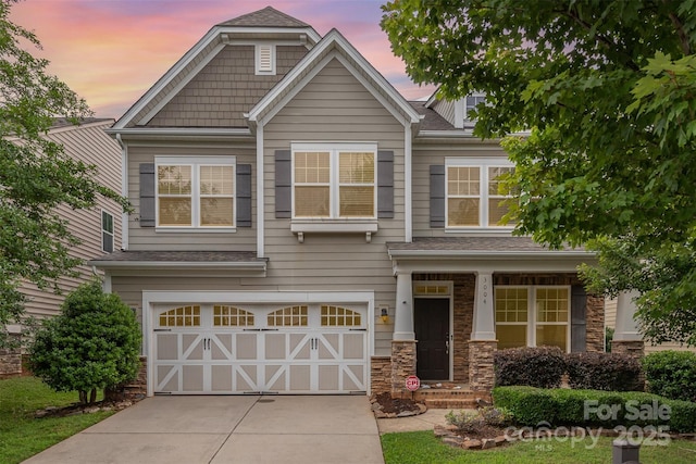 3004 Fallondale Rd, Waxhaw, NC 28173 - view of front of home featuring a garage, driveway, stone siding, and a shingled roof