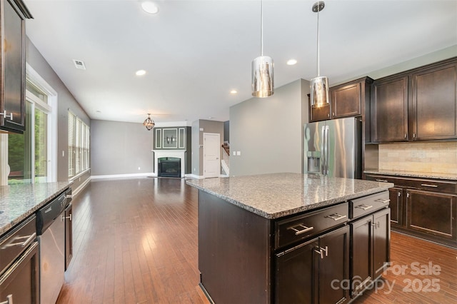 3004 Fallondale Rd, Waxhaw, NC 28173 - kitchen with stainless steel appliances, dark brown cabinets, decorative backsplash, and recessed lighting