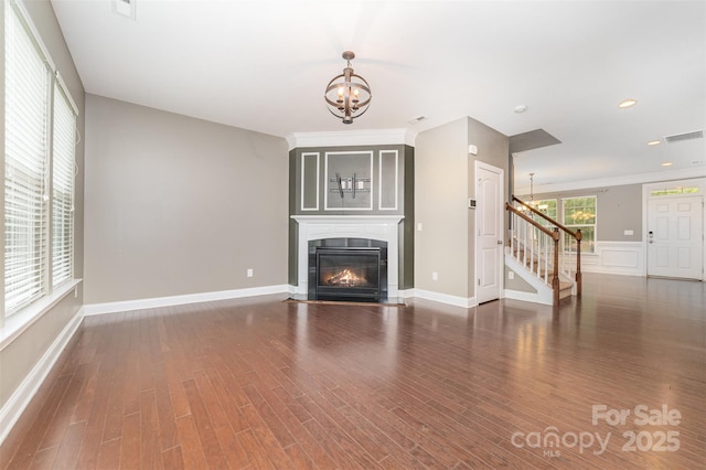 3004 Fallondale Rd, Waxhaw, NC 28173 - unfurnished living room featuring a chandelier, stairway, wood finished floors, a glass covered fireplace, and baseboards