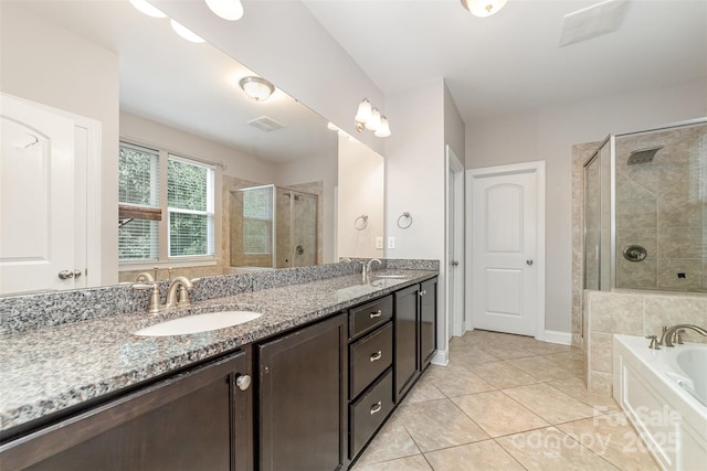 3004 Fallondale Rd, Waxhaw, NC 28173 - full bath featuring a stall shower, tile patterned flooring, double vanity, a bath, and baseboards