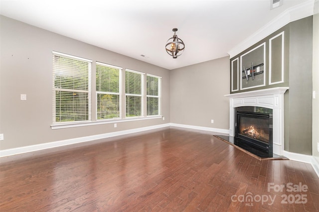3004 Fallondale Rd, Waxhaw, NC 28173 - unfurnished living room with a glass covered fireplace, baseboards, dark wood-style flooring, and a chandelier