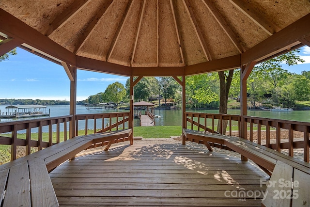 wooden terrace featuring a gazebo and a water view