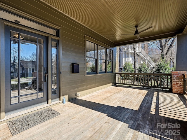 wooden deck with ceiling fan and a porch