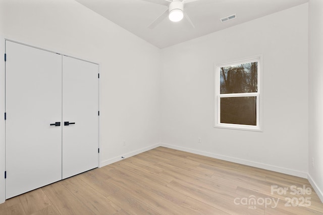 unfurnished bedroom featuring ceiling fan, light hardwood / wood-style flooring, and a closet