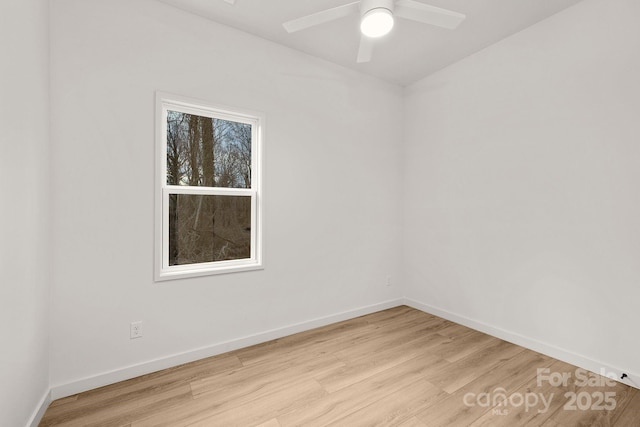 empty room with ceiling fan and light hardwood / wood-style flooring