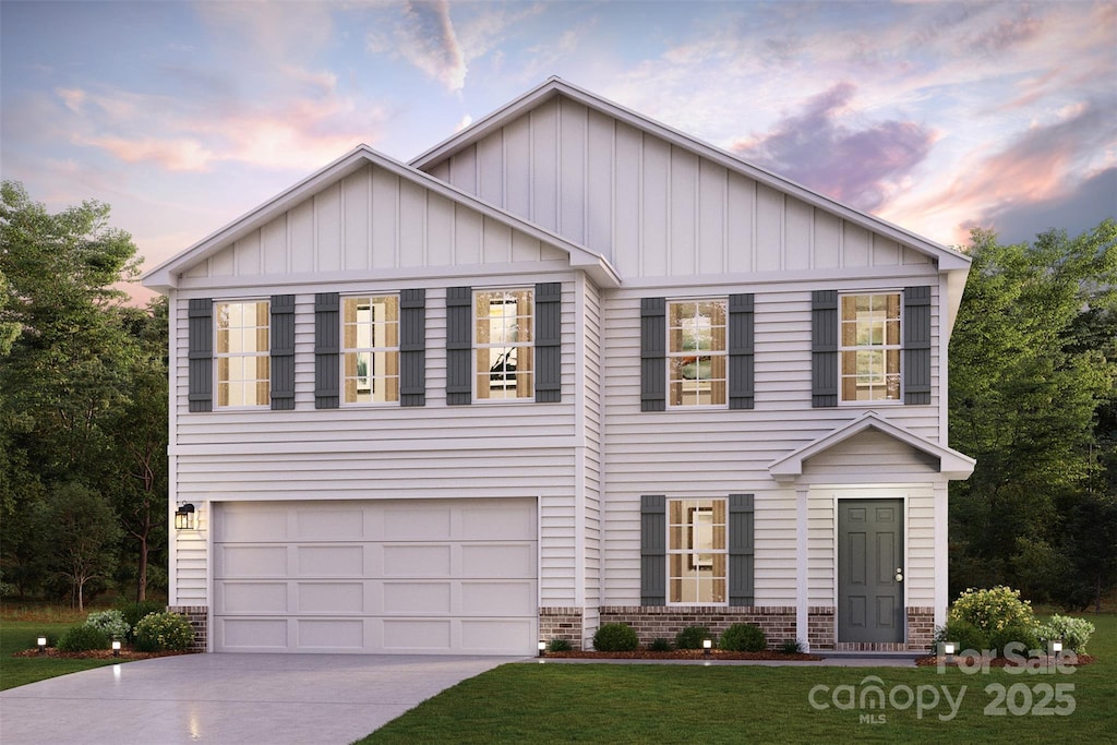 view of front of house with brick siding, board and batten siding, an attached garage, and concrete driveway