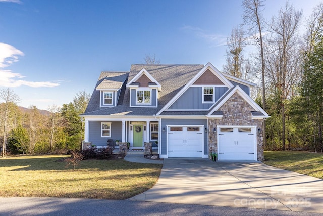 craftsman inspired home featuring an attached garage, a front lawn, board and batten siding, and concrete driveway