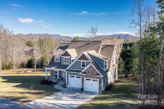 view of front of home featuring driveway, a forest view, a mountain view, board and batten siding, and a front yard