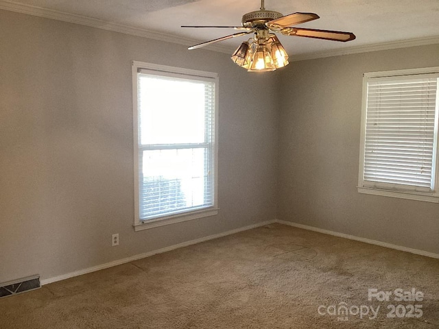 unfurnished room featuring ceiling fan, crown molding, and carpet