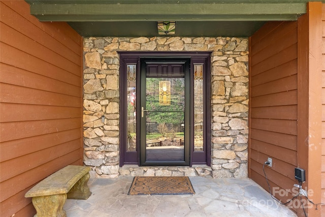 entrance to property with stone siding