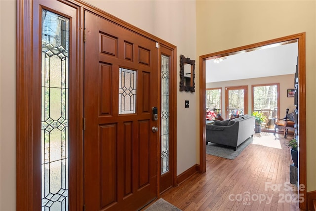 foyer with light wood finished floors and baseboards