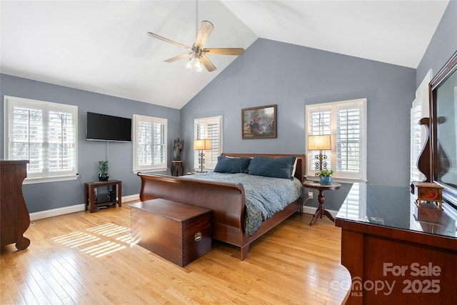 bedroom with baseboards, high vaulted ceiling, ceiling fan, and light wood-style floors