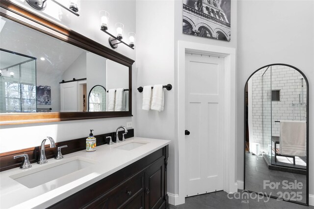 full bath with lofted ceiling, double vanity, and a sink