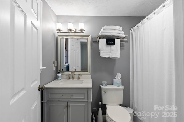 full bath featuring toilet, a shower with shower curtain, a textured ceiling, and vanity