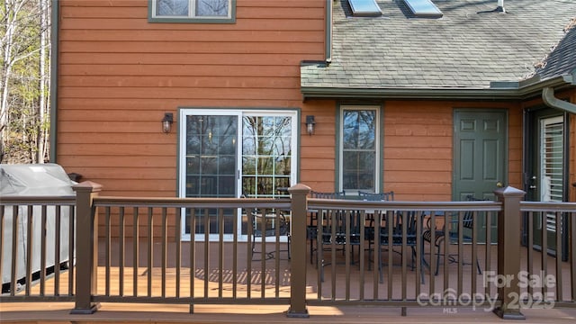 exterior space featuring roof with shingles