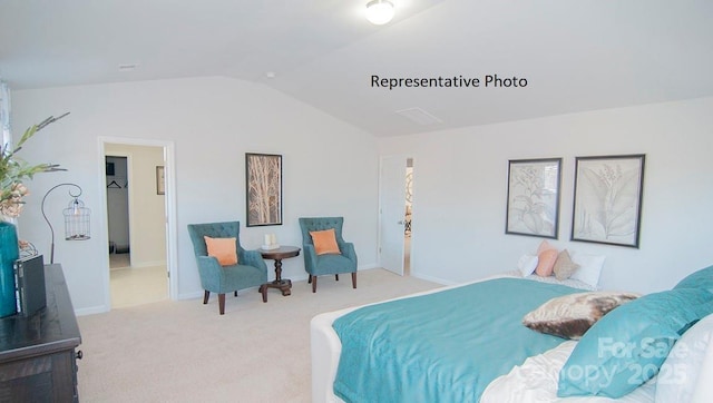 carpeted bedroom with lofted ceiling