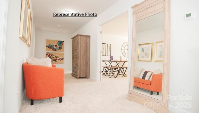 hallway with light colored carpet