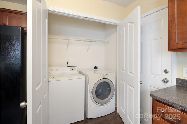 laundry room featuring dark hardwood / wood-style floors and washing machine and clothes dryer