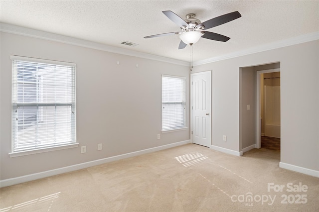 unfurnished bedroom featuring light colored carpet, ornamental molding, a closet, ceiling fan, and a textured ceiling