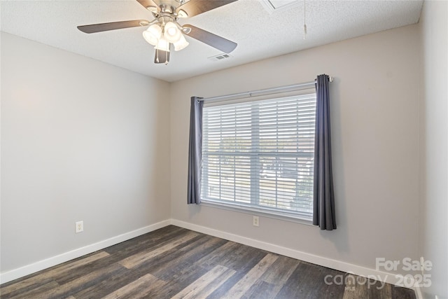 unfurnished room featuring ceiling fan, dark wood-type flooring, and a textured ceiling