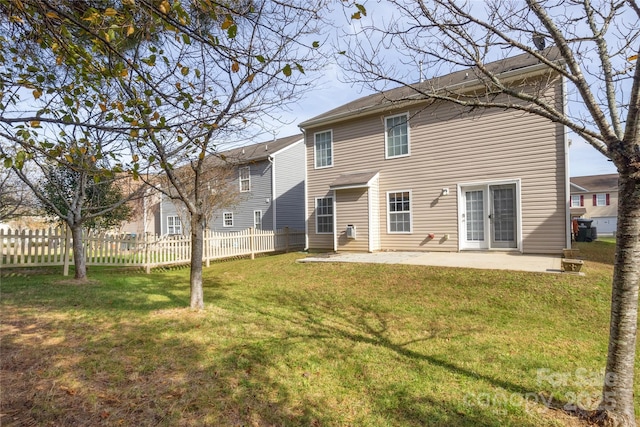 rear view of property featuring a patio area and a lawn