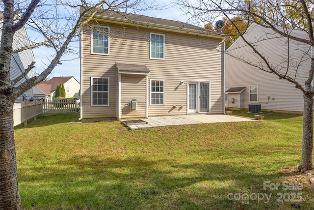 rear view of property featuring a lawn, a patio, and central air condition unit