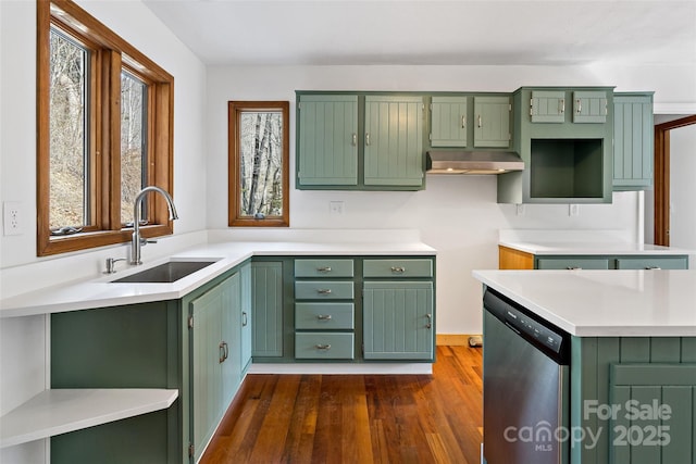 kitchen with dark wood-style flooring, a sink, green cabinets, light countertops, and dishwasher