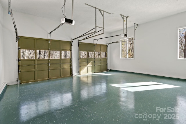 garage featuring a garage door opener and baseboards