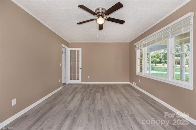 empty room with light wood-type flooring, crown molding, a textured ceiling, and ceiling fan