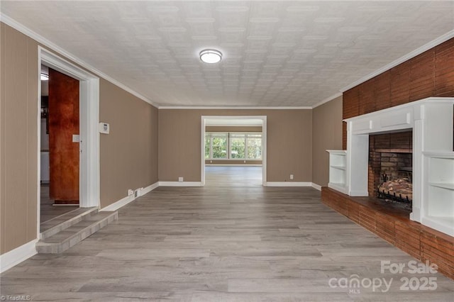 unfurnished living room featuring ornamental molding, light wood-type flooring, and a tile fireplace