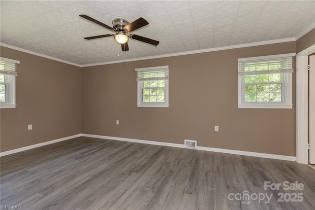 unfurnished room with ceiling fan, crown molding, and wood-type flooring